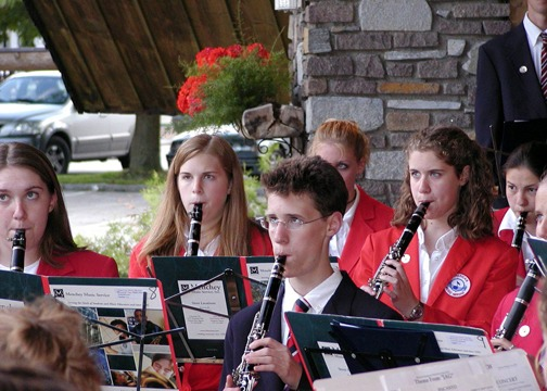 Students performing in a band ensemble during an AMA music tour.