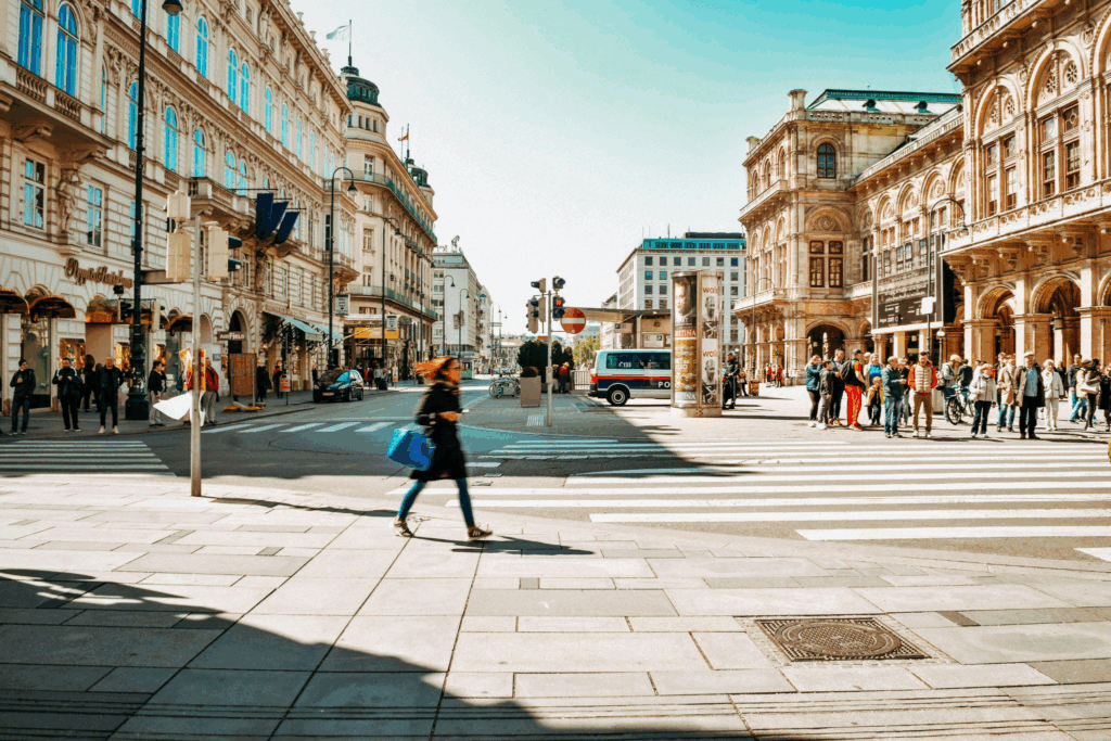 A view of Vienna’s historic city center with people walking among classical architecture.