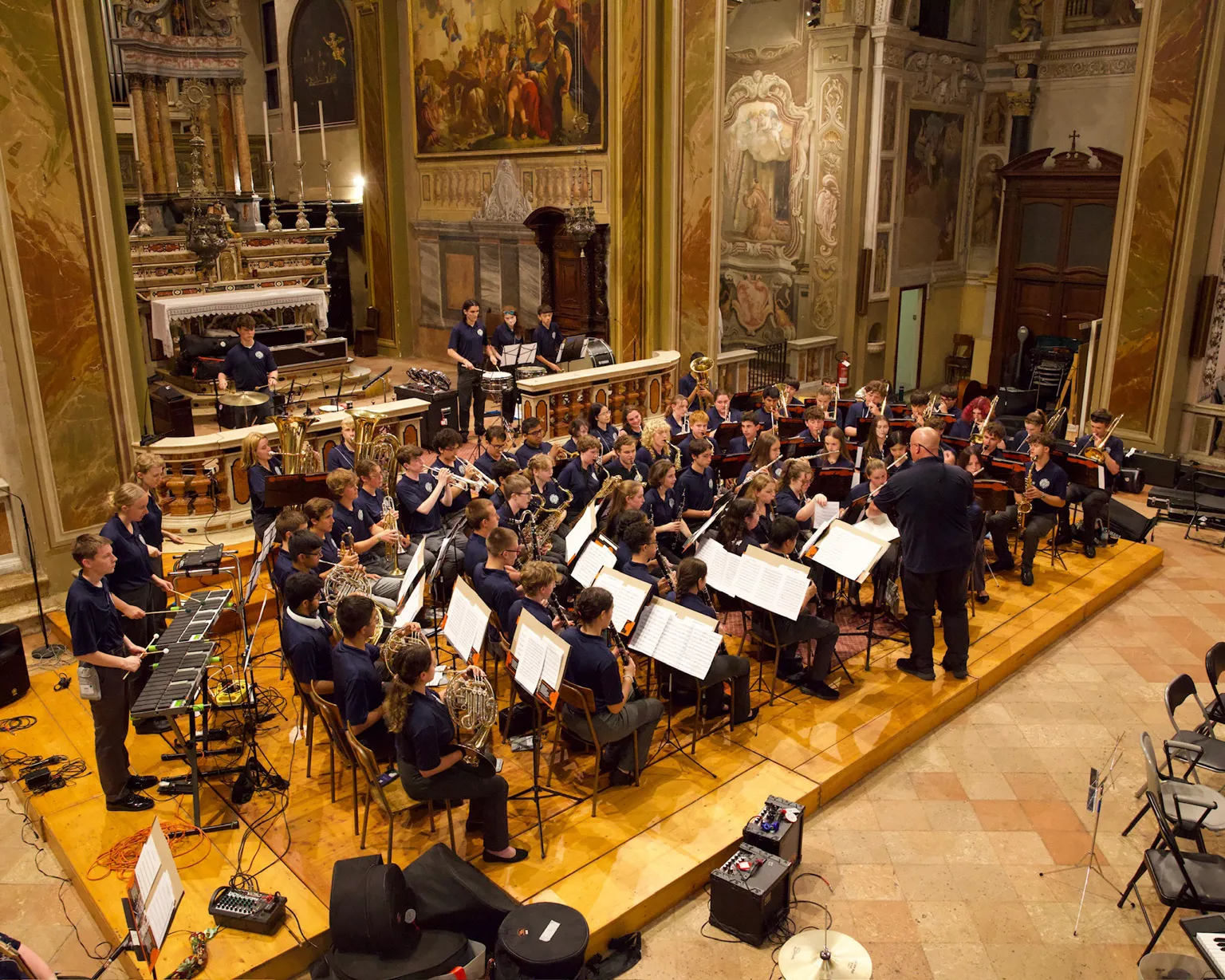 High school ensemble performing in a European cathedral during the AMA Bronze Tour.