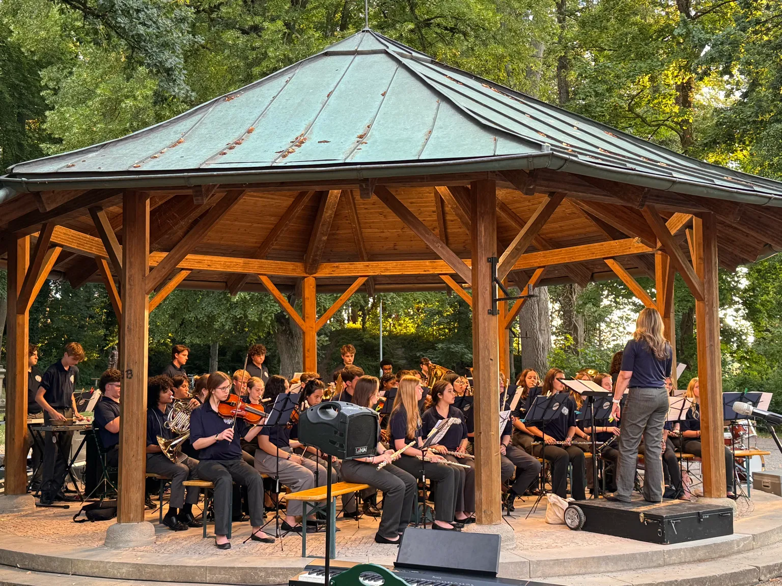 AMA Gold Tour ensemble performing in an outdoor pavilion.