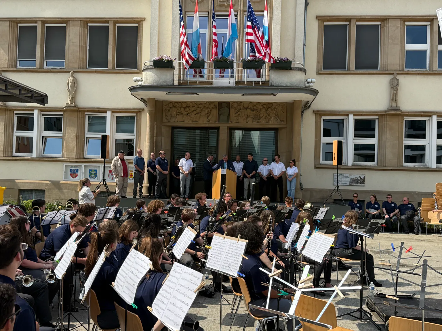 Students performing outdoors during the AMA concert in Luxembourg.