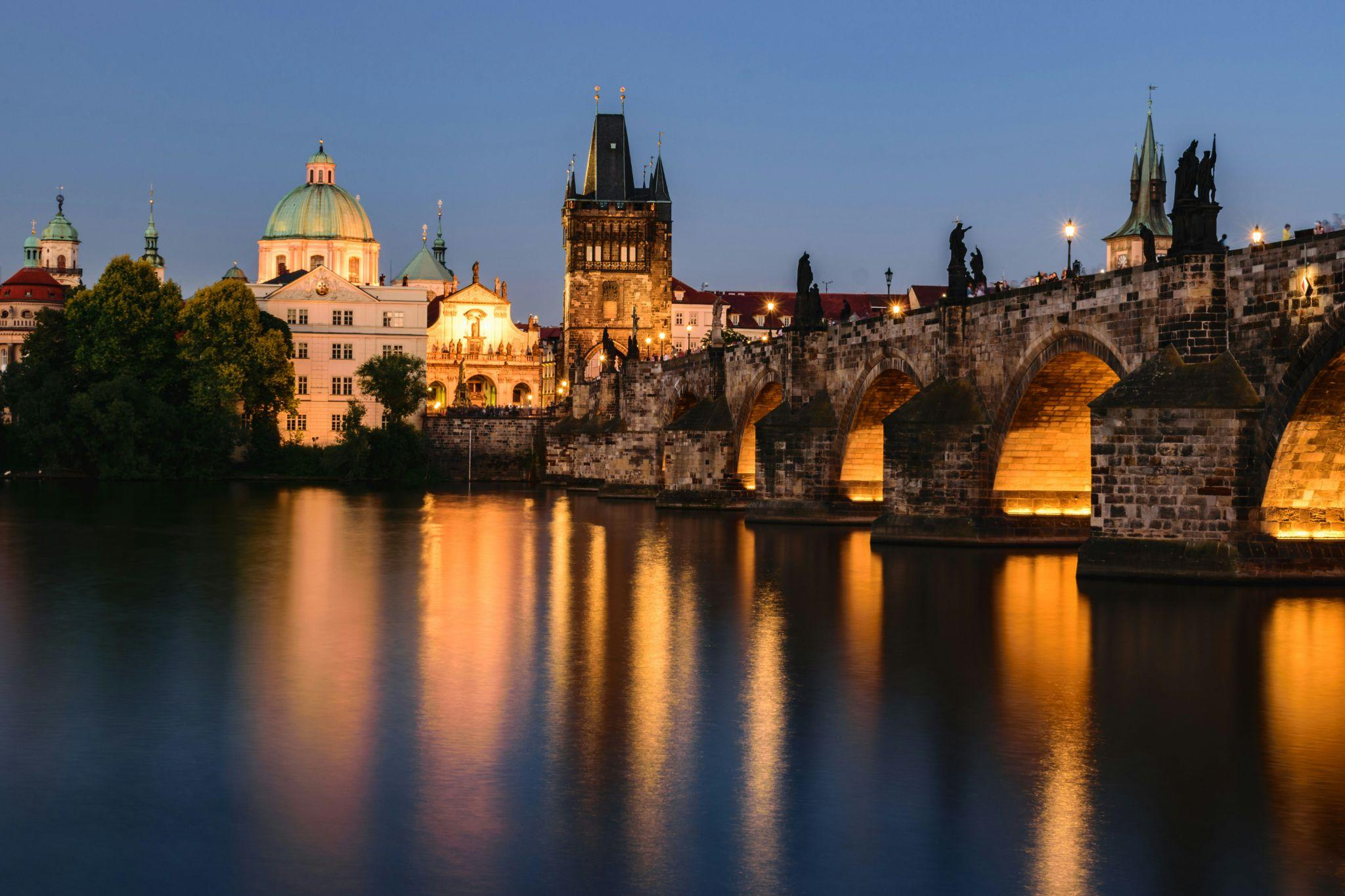 The Charles Bridge and Prague skyline illuminated at night in the Czech Republic.