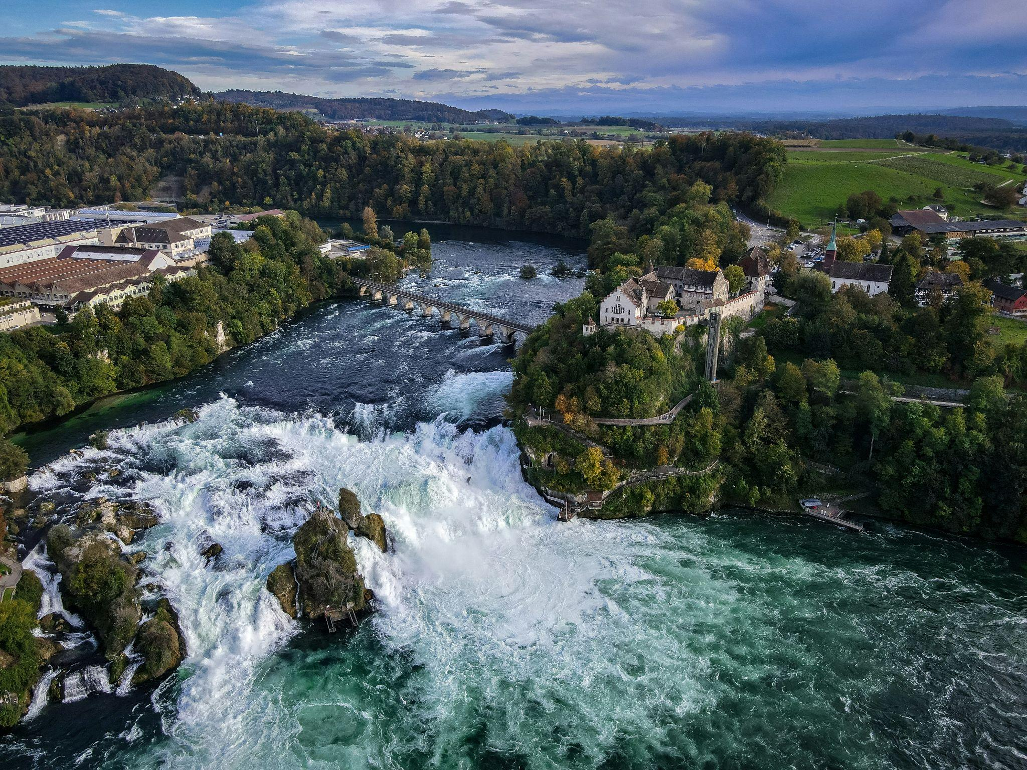 Aerial view of the Rhine Falls cascading through the Swiss countryside.
