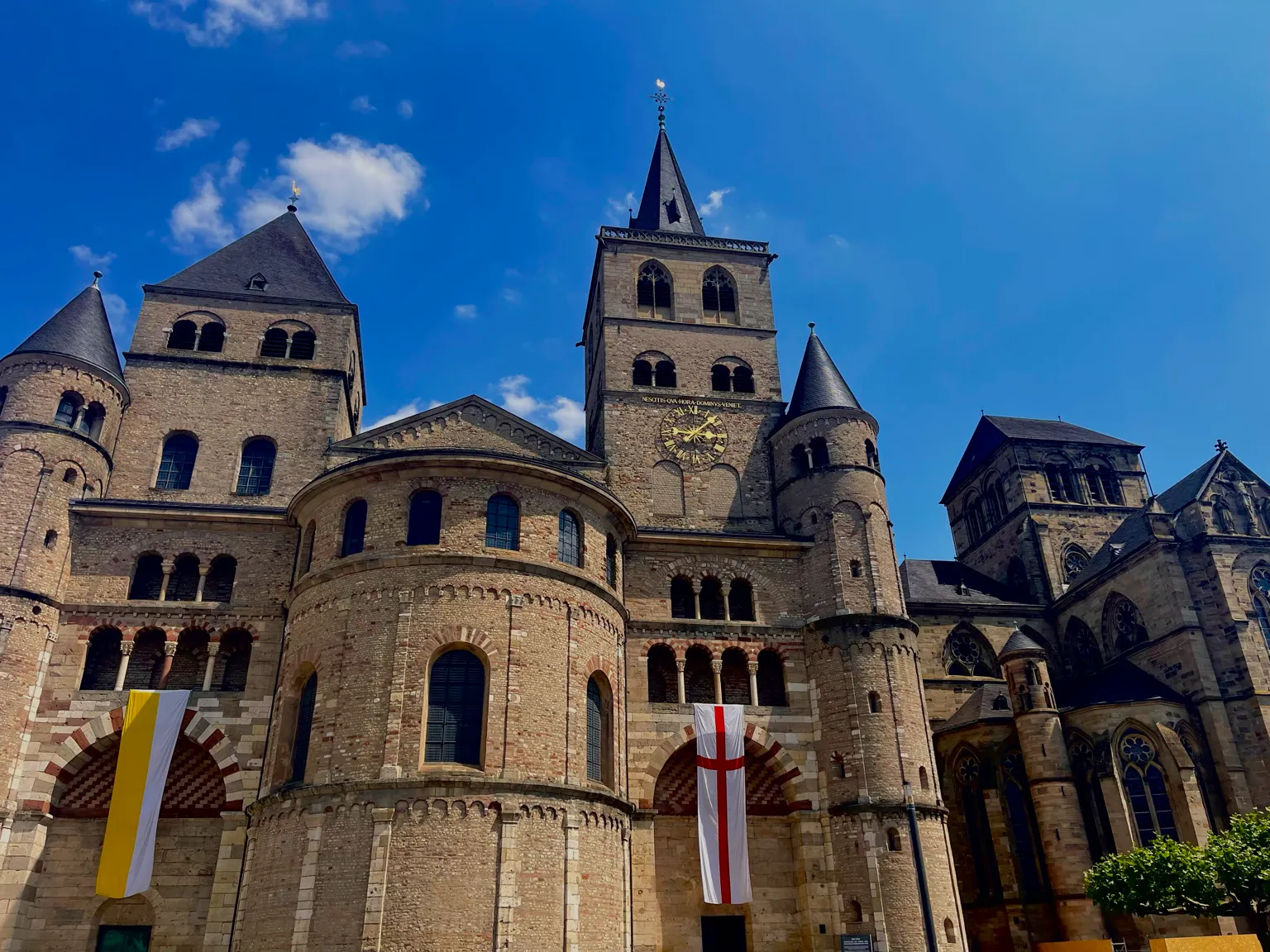 Exterior of Trier Cathedral under a blue sky in Germany.