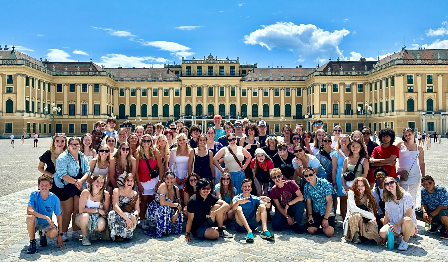 AMA Gold Tour students posing together outside Schönbrunn Palace in Vienna.