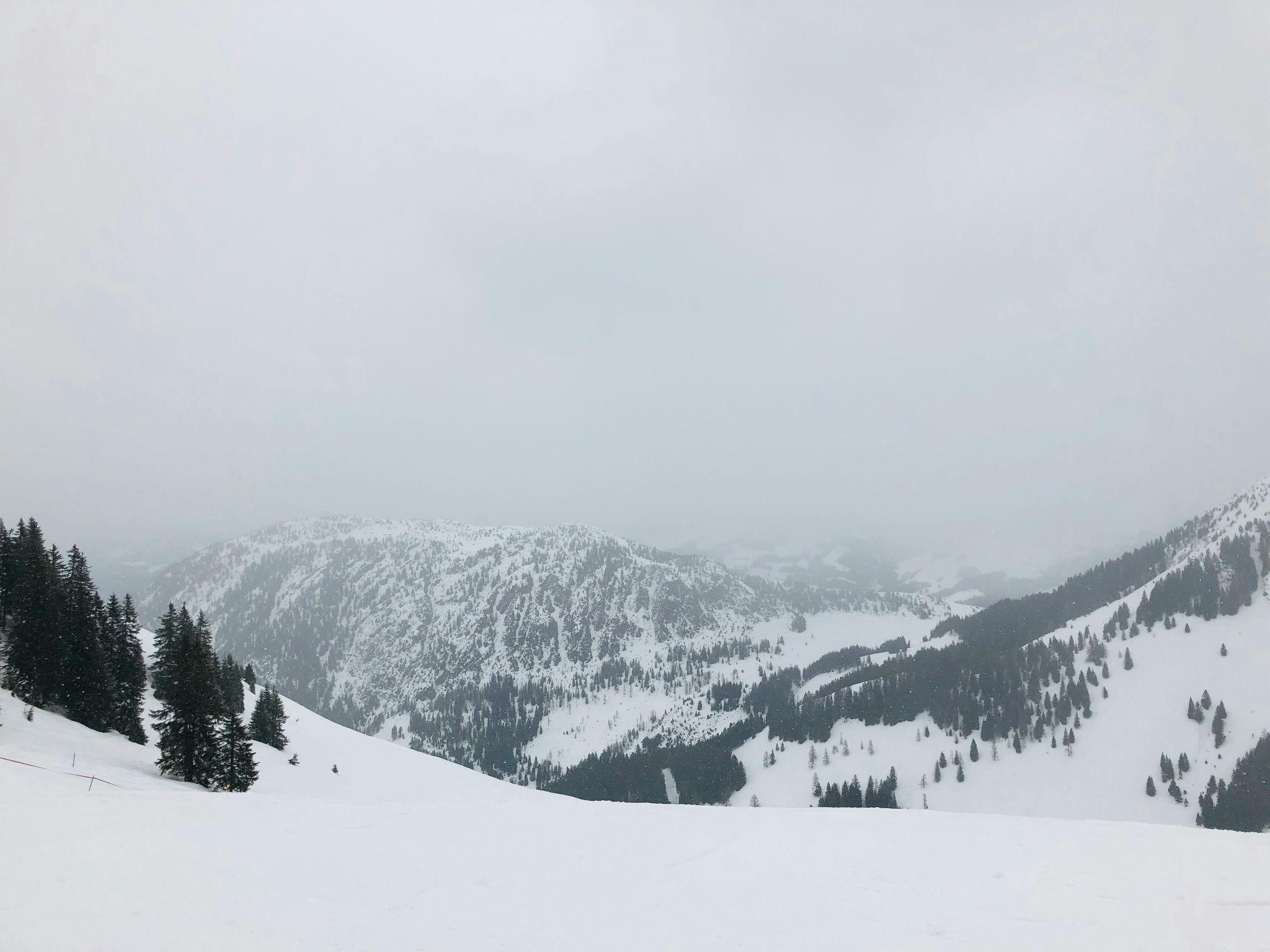 Snow-covered alpine peaks surrounding the village of Westendorf, Austria.