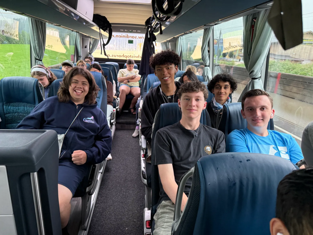High school students seated on a tour bus during European travel