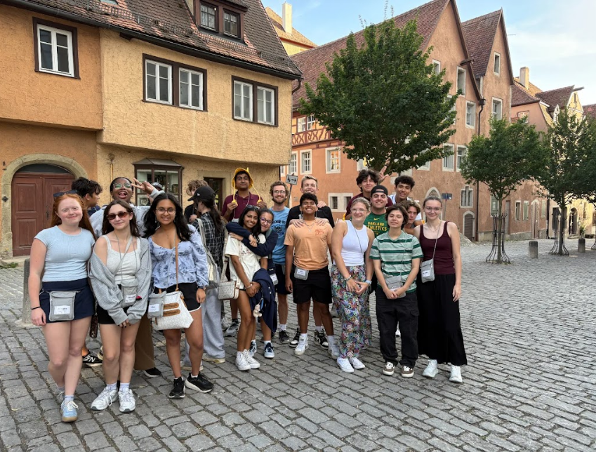 Adult musicians posing together during an international music performance tour in Europe.