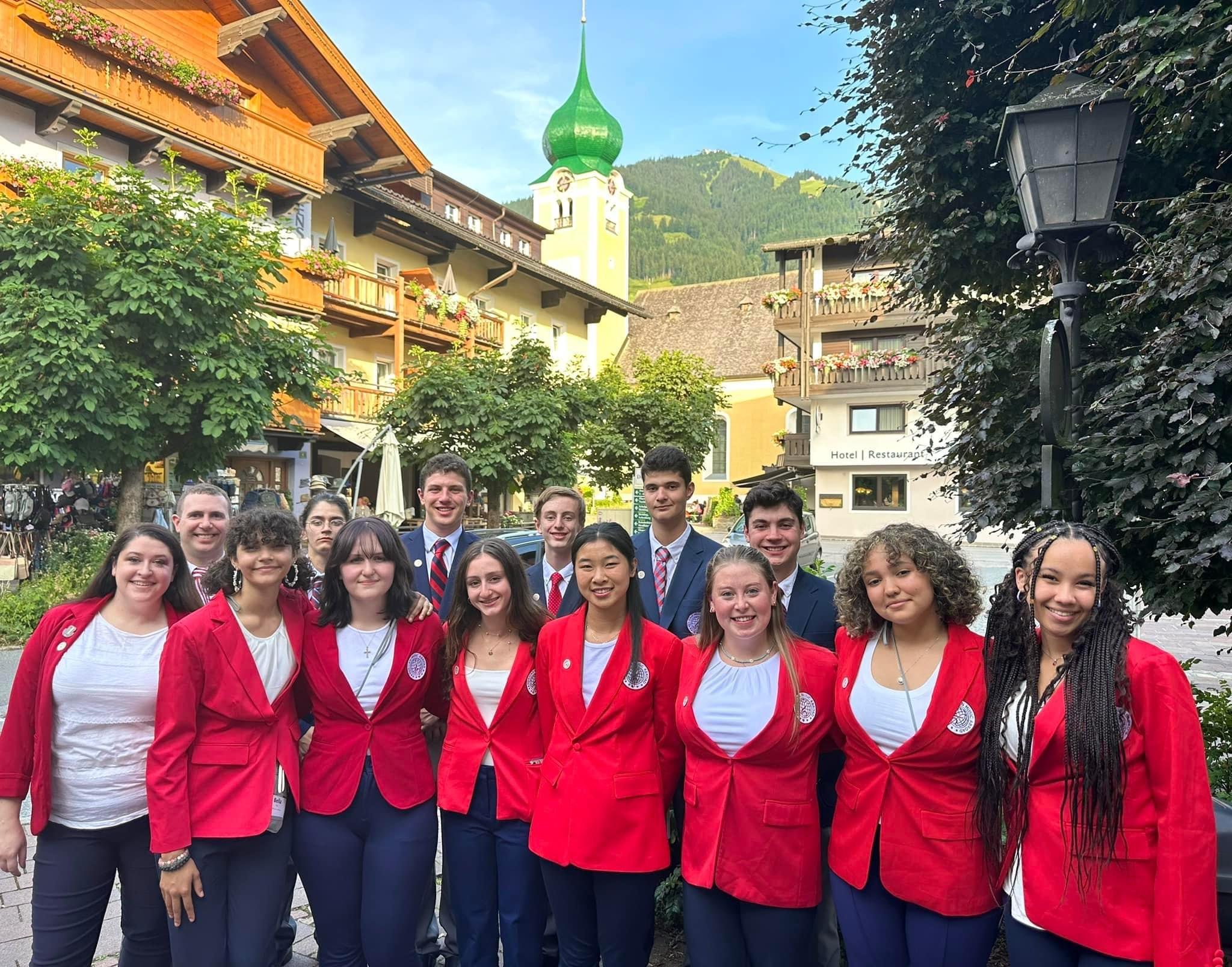 High school musicians standing together in a European town during a music performance tour in Europe.