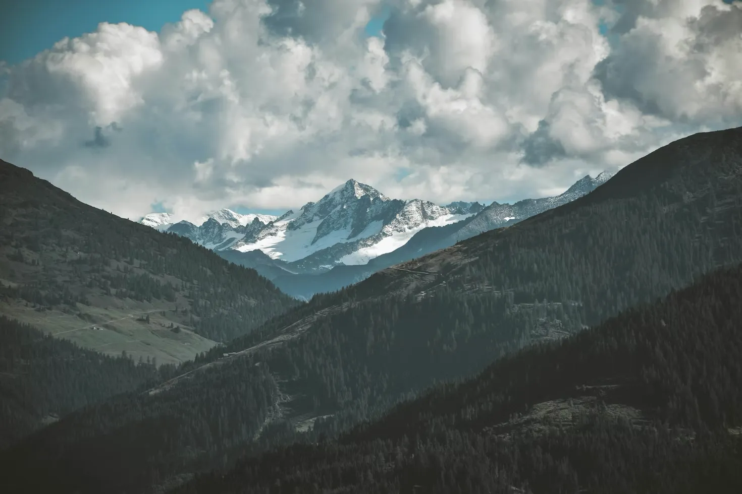 Panoramic view of Westendorf in the Austrian Alps with snow-capped mountains and green valleys.