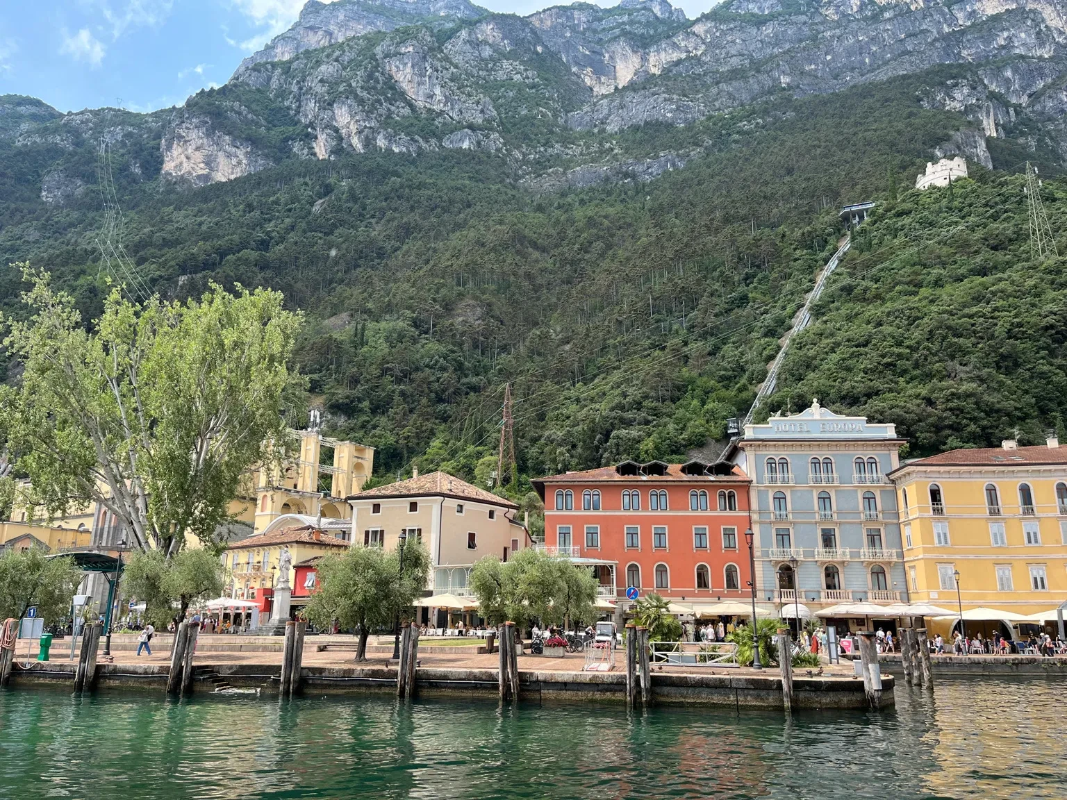 Colorful lakeside town with mountains and waterfront buildings in Europe.