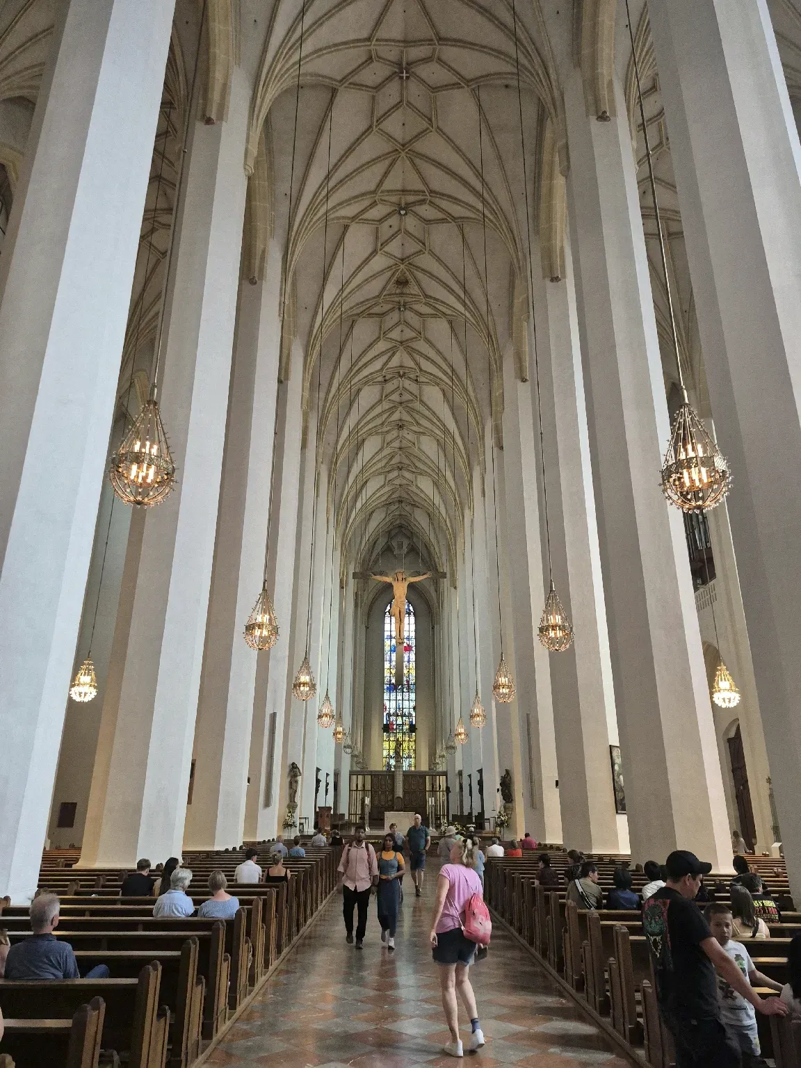 Interior of St. Stephen’s Cathedral in Vienna with tall columns and a vaulted ceiling.