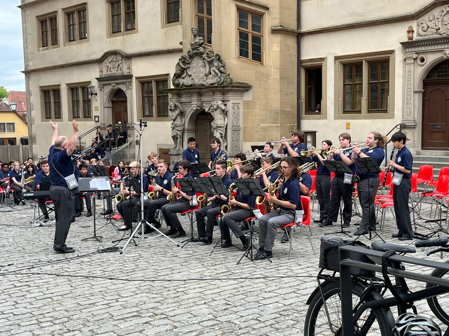 Student musicians performing in a town square.