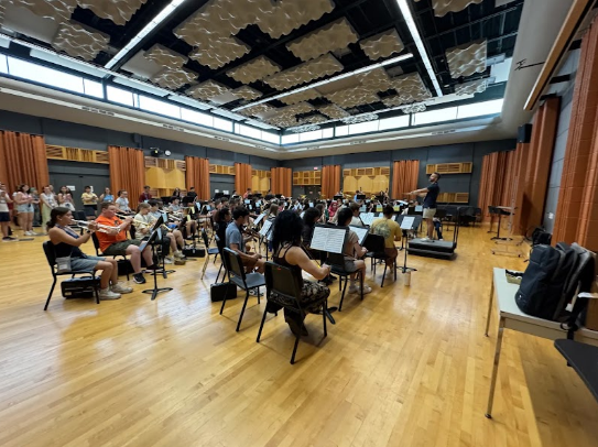 Student performers build ensemble skills, focus, and confidence through guided rehearsal before live performance.